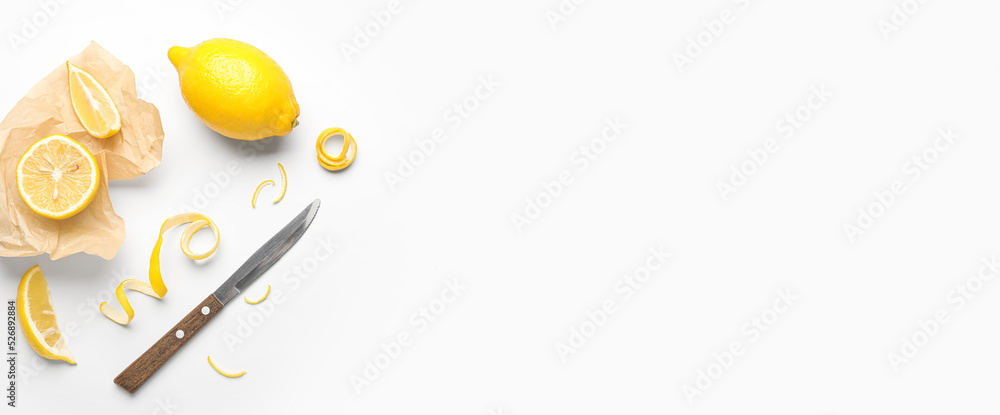 Ripe lemons, peel and knife on white background with space for text Ripe lemons, peel and knife on white background with space for text
