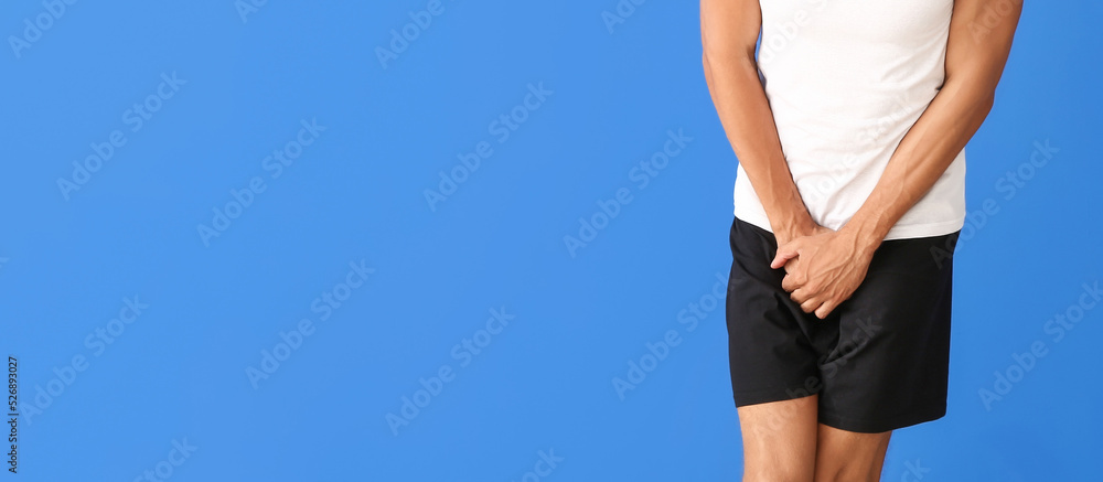 Man with problem of frequent urination on blue background with space for text. Prostate cancer concept Man with problem of frequent urination on blue background with space for text. Prostate cancer concept