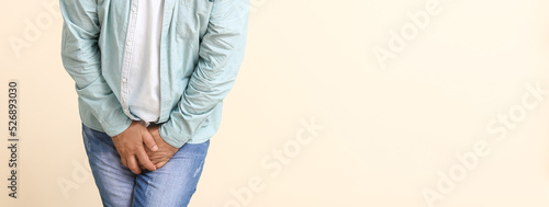 Konstfotografi Man with problem of frequent urination on light background with space for text