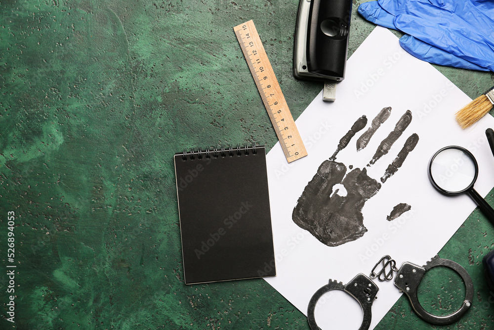 Paper sheet with palm print, notebook and FBI agent's accessories on color background Paper sheet with palm print, notebook and FBI agent's accessories on color background