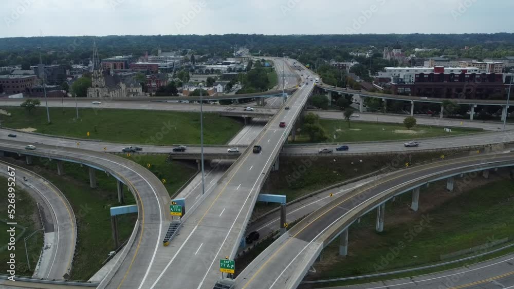 Busy Traffic Drives In All Directions Through Metropolitan City On Highway With Multiple Intersections Busy Traffic Drives In All Directions Through Metropolitan City On Highway With Multiple Intersections