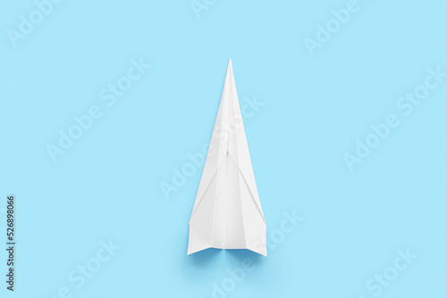 White paper plane on blue background