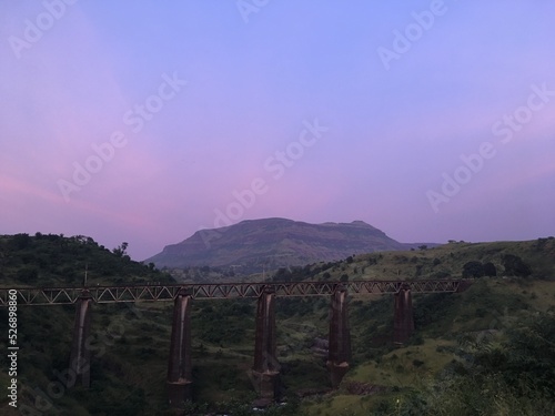 sunset over bridge and the mountains