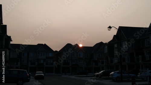 setting sun over a house