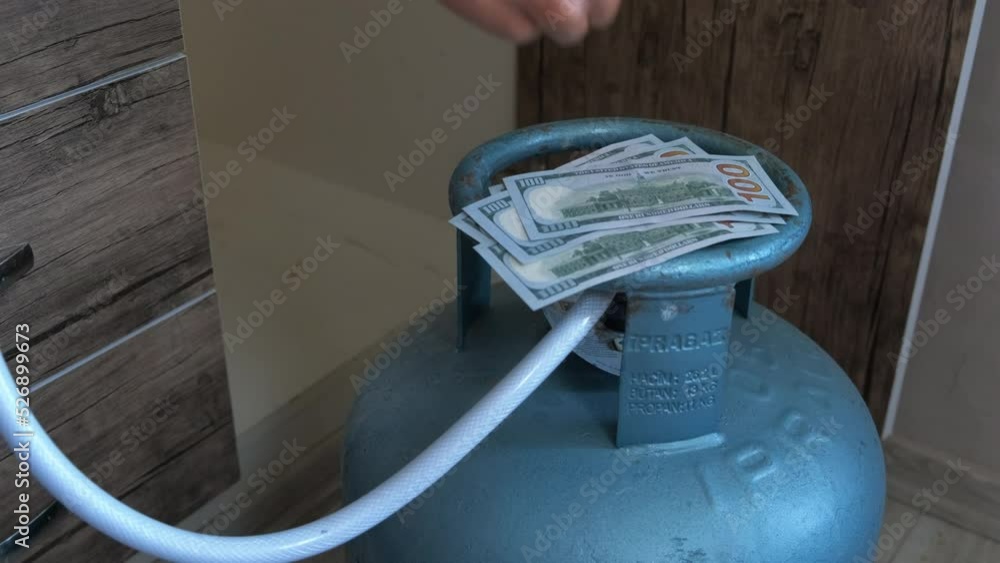 Count money for gas consumation. Expensive gas. A man count money for gas consumation from gas cylinder in Europe.