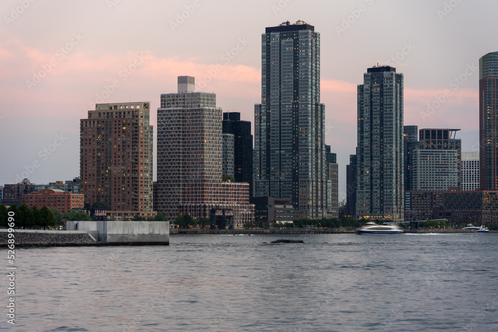 ferry passing in front of long island city skyline ferry passing in front of long island city skyline