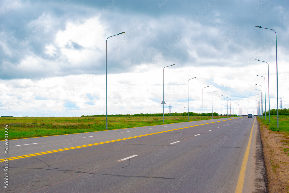 perspective of paved road and sky before rain