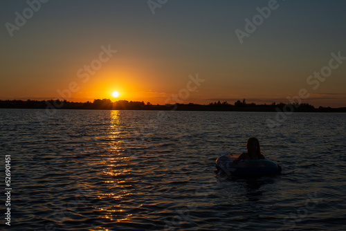 beautiful sunset and silhouette of a man on the river in summer in Kazakhstan © Vyacheslav