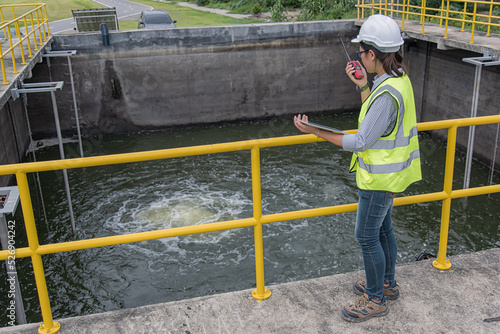 workers at work. Service engineer woman using computer laptop on waste water plant. © VIEWFOTO STUDIO