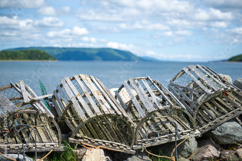 Fotografija Old lobster traps lined up on the shore near Baddeck, Nova Scotia Canada