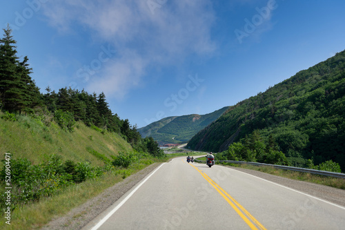 Motorcycles riding on the Cabot Trail in Cape Breton Highlands National Park, Nova Scotia, Canada on a summer day