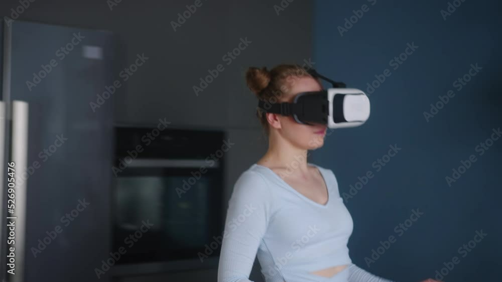 Futuristic concept of woman avatar in virtual reality headset makes food in kitchen. Female cooking meal in metaverse minimalistic interior. Person puts pot on a gas stove to boil water in cyber space Futuristic concept of woman avatar in virtual reality headset makes food in kitchen. Female cooking meal in metaverse minimalistic interior. Person puts pot on a gas stove to boil water in cyber space
