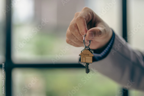house sales representative holding keys by businessman The agent gives the key to the customer. home buying real estate ideas