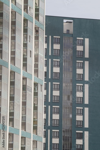 Full-color vertical photo. The geometric composition is made up of sections of the facades of city buildings.