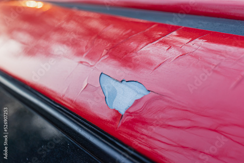 The red car paint peels off, the car paint cracks and falls off.