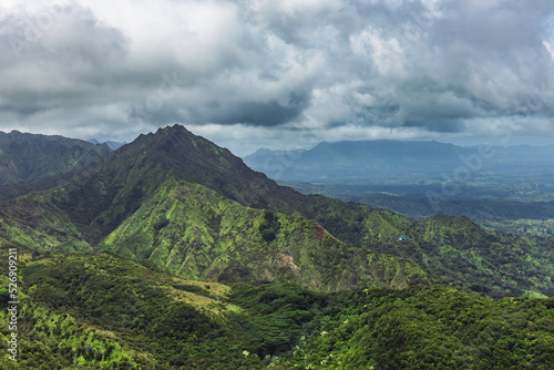 Helicopter touring the mountains of the Gardern Isle - Kauai, Hawaii on an overcast day