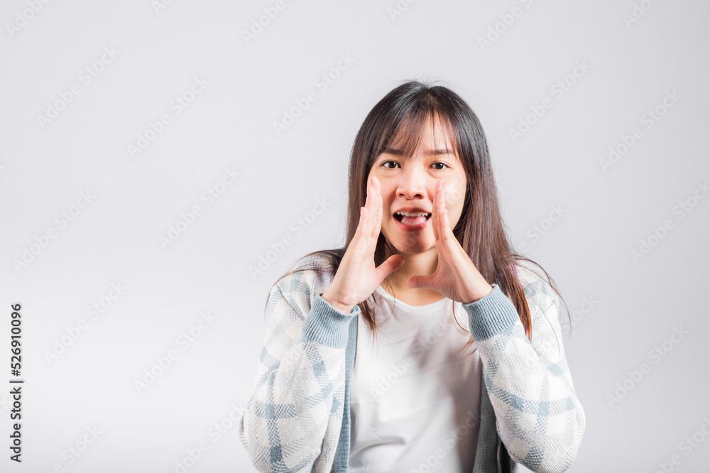 Happy woman hand on mouth talking whisper secret rumor, Asian beautiful young female excited tell gossip, studio shot isolated on white background with copy space Happy woman hand on mouth talking whisper secret rumor, Asian beautiful young female excited tell gossip, studio shot isolated on white background with copy space