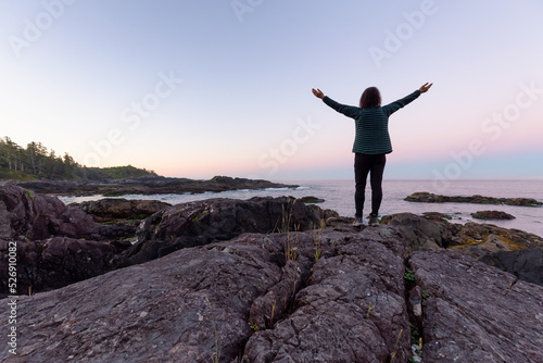 Adventurous Women with Hands Up, Looking out to Ocean in Canadian Nature at Sunrise. Ancient Cedars Loop Trail. Ucluelet, British Columbia, Canada. Adventure Travel.