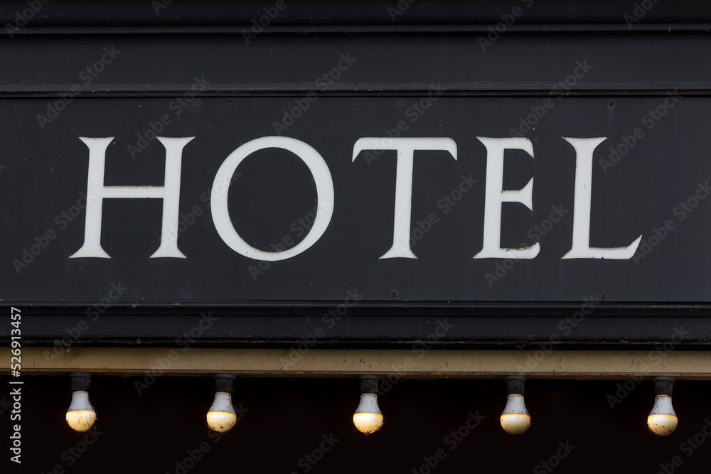 Obraz premium Hotel sign on old black wall