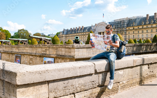 Photography Young men with a tourist map in hand in the city of Paris France