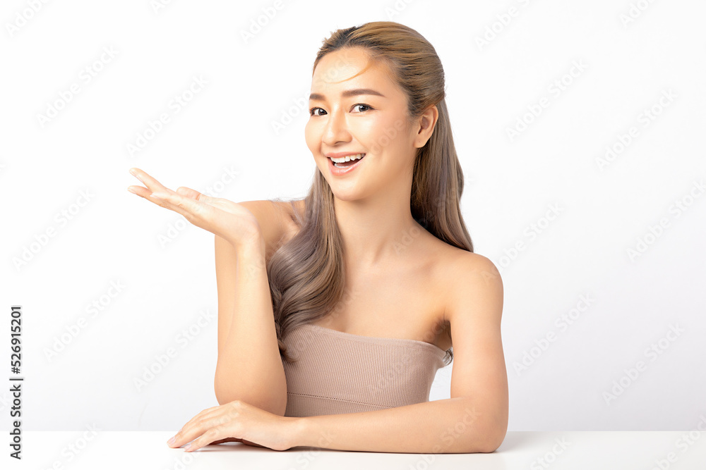 Happy beautiful asian woman looking to camera and showing empty copy space on the open hand. Asian girl beauty face skincare and health wellness, Facial treatment, Isolated on white background. Happy beautiful asian woman looking to camera and showing empty copy space on the open hand. Asian girl beauty face skincare and health wellness, Facial treatment, Isolated on white background.
