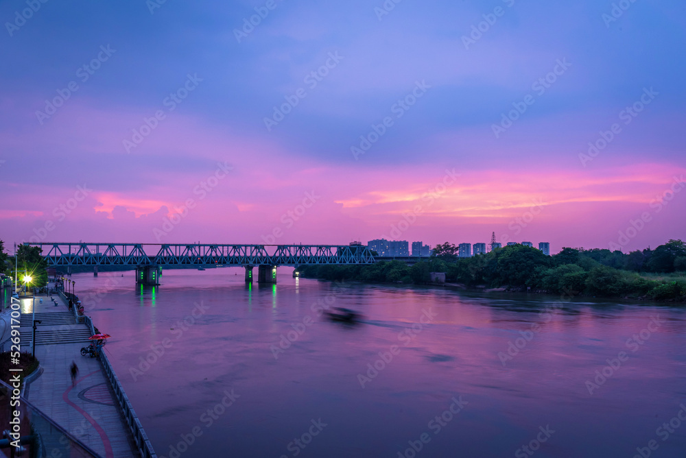 Cityscape of Shilong South Bank Park in Dongguan, China. Guangzhou-Shenzhen Railway at sunset. Landscape of Bank of Dong river in summer.