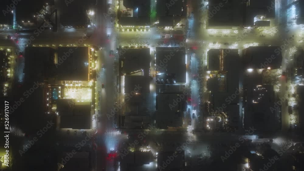 Aspen town aerial overhead view at night with snow winter time Christmas. Fly over winter streets with night illumination. Street lights and small town traffic, night drone video birds view, Colorado Aspen town aerial overhead view at night with snow winter time Christmas. Fly over winter streets with night illumination. Street lights and small town traffic, night drone video birds view, Colorado