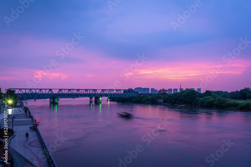 Cityscape of Shilong South Bank Park in Dongguan, China. Guangzhou-Shenzhen Railway at sunset. Landscape of Bank of Dong river in summer. © YOUMING VISION