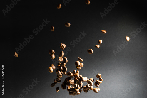 Several coffee beans isolated on black background with reflection. Culinary coffee background.