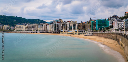 Panorama of La Concha bay, beach and waterfront hotels in San Sebastian, Spain
