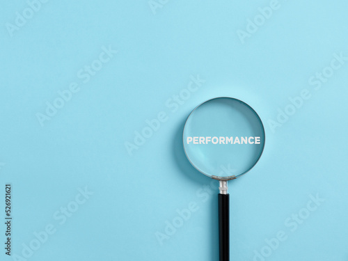 Magnifier focuses on the word performance. Analyzing or reviewing business job or employee performance