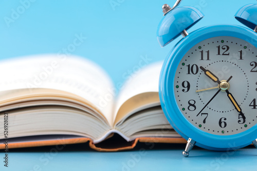 Alarm clock and an open book