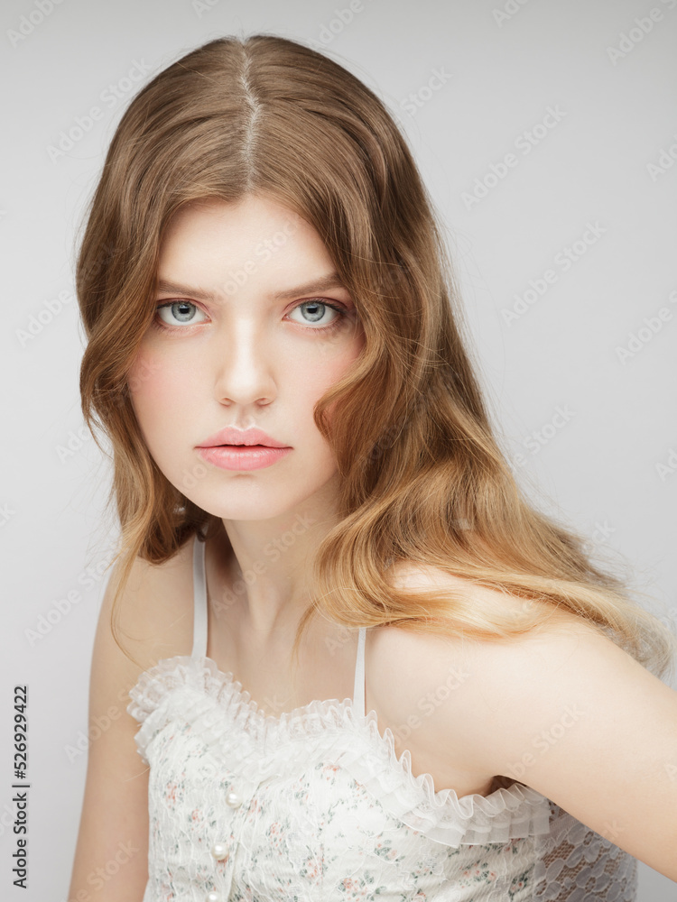 One young woman looking at camera. Vertical studio portrait of young charming girl. One young woman looking at camera. Vertical studio portrait of young charming girl.