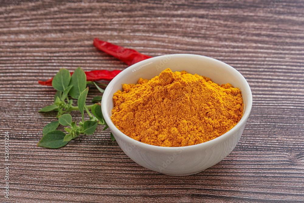 Yellow vibrant curcuma powder in the bowl Yellow vibrant curcuma powder in the bowl