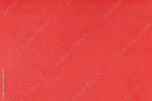Texture of natural red fabric or cloth. Fabric texture diagonal weave of natural cotton or linen textile material. Blue canvas background. Decorative fabric for curtain, furniture, walls, clothes