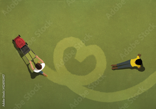 Couple mowing heart-shape in lawn with lawn mower
