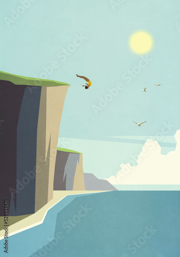 Woman diving off cliff into idyllic summer ocean
 photo