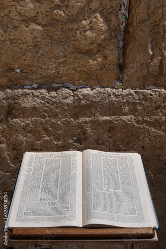 A Talmud open to the text from the tractate Ketubot rests on a prayer stand in front of the Western Wall in Jerusalem. photo