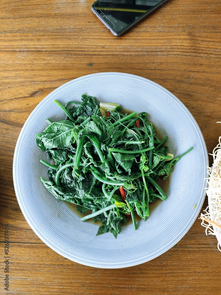 Stir fried vegetables in oyster sauce on a white plate. Healthy food. Stir fried vegetables in oyster sauce on a white plate. Healthy food.
