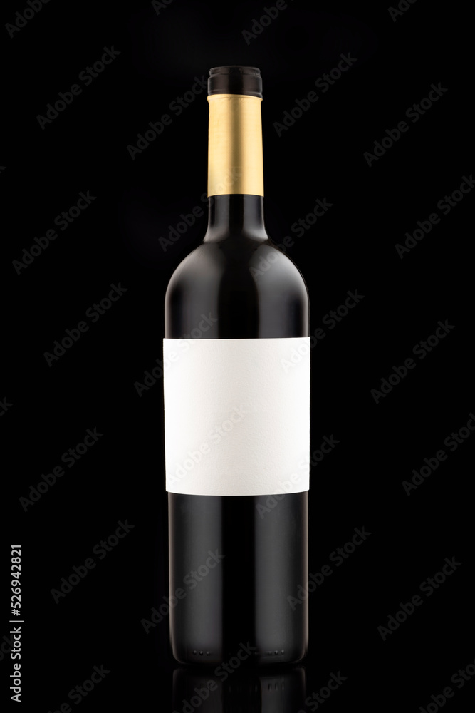 A bottle of red expensive wine on a black background vertical close-up photo. blank label copy space