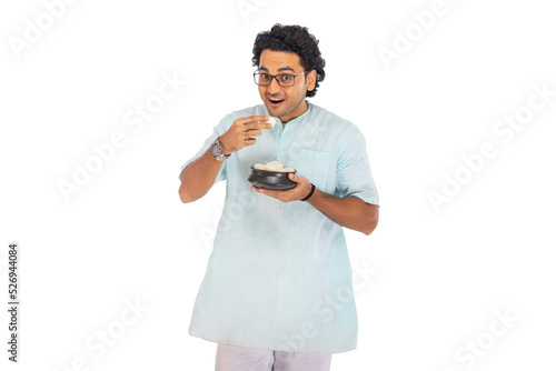 Portrait of Bengali man having rosogolla photo