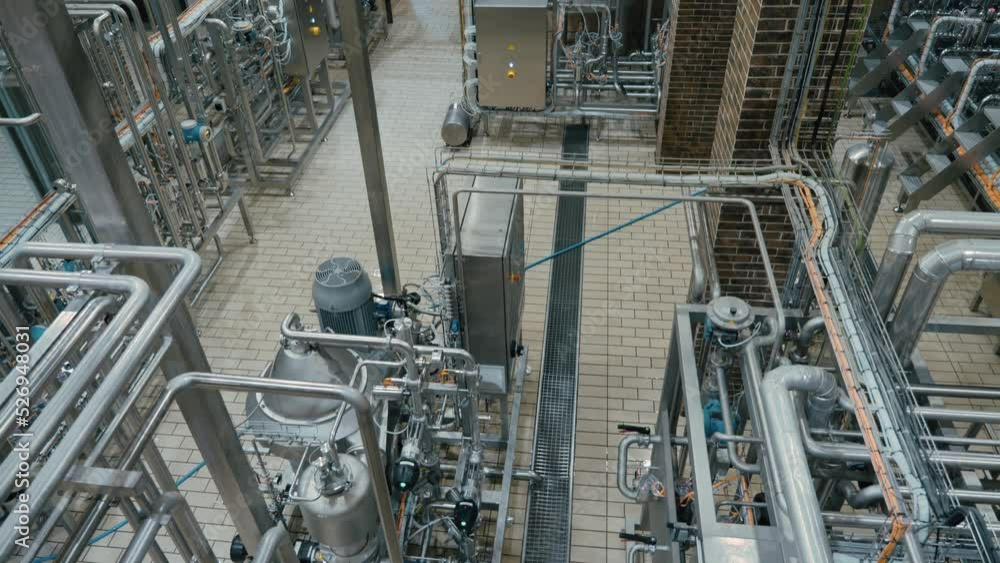 Modern craft brewery with steel pipelines, tanks reservoirs and technique equipment. Craft beer production. Modern craft brewery with steel pipelines, tanks reservoirs and technique equipment. Craft beer production.