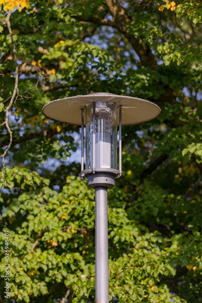 Modern LED street lamp provides energy saving lighting in a park path in central Europe