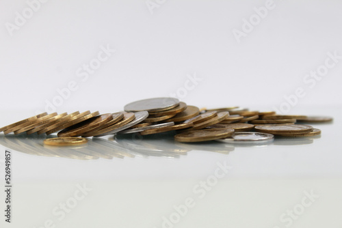 A pile of ukrainian silver and golden coins - hryvnia money on a white blank background, the concept of selctive finance business investment