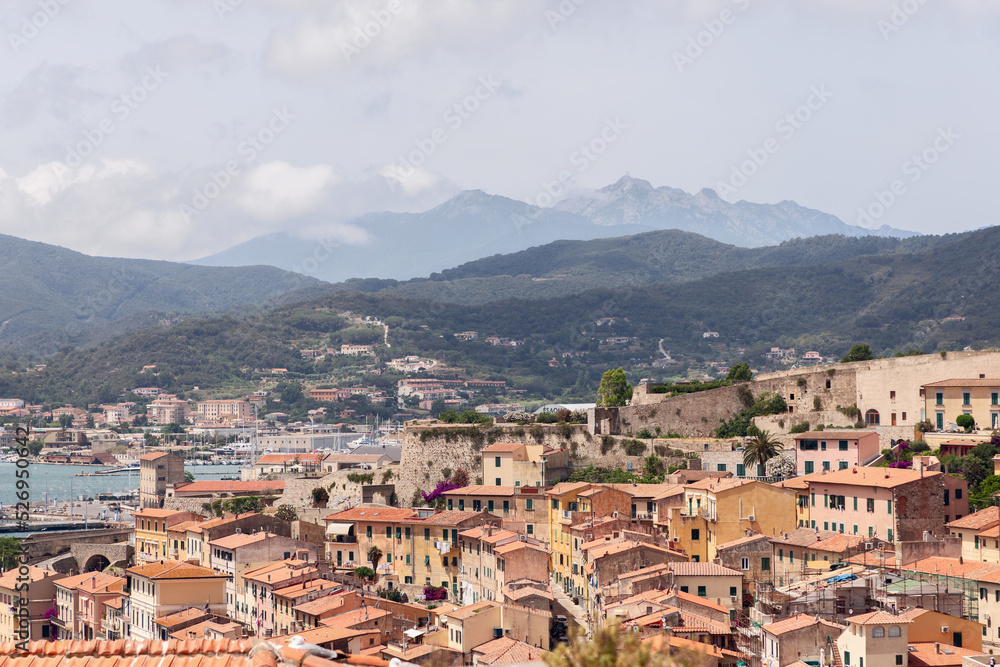 Typical Italian houses and tiled roofs in port of Portoferraio, Province of Livorno, Island of Elba, Italy