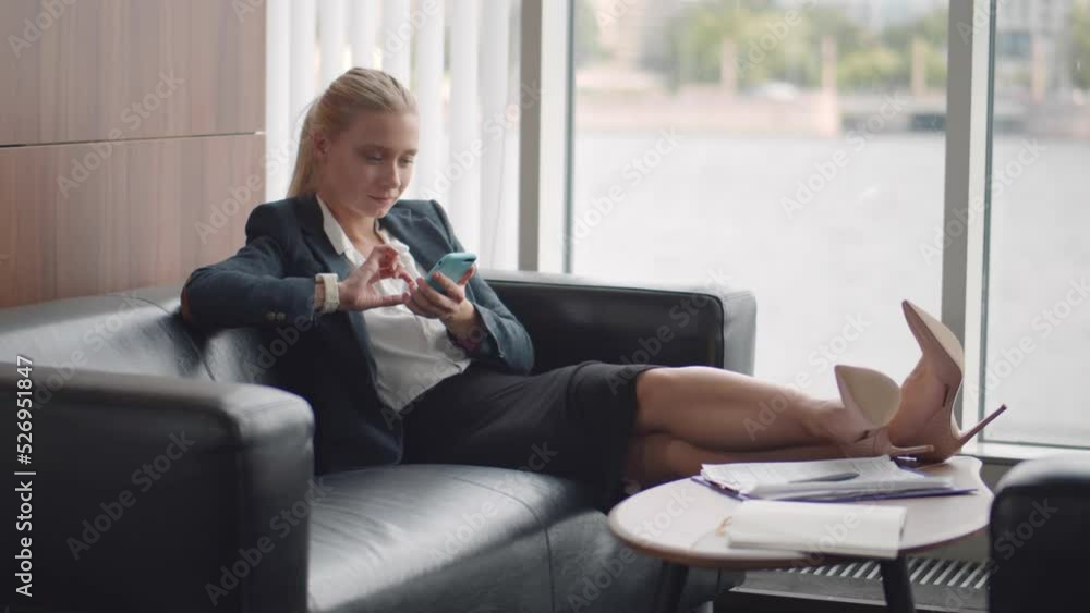 Caucasian businesswoman chat on mobile phone in lobby at office. Realtime Caucasian businesswoman chat on mobile phone in lobby at office. Realtime