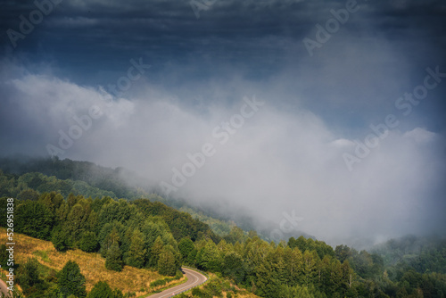 Beautiful summer mountain landscape, clouds over a small village in a mountain gorge in Serbia