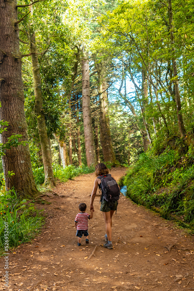 A mother with her son on the footpath at Levada do Caldeirao Verde, Queimadas, Madeira A mother with her son on the footpath at Levada do Caldeirao Verde, Queimadas, Madeira