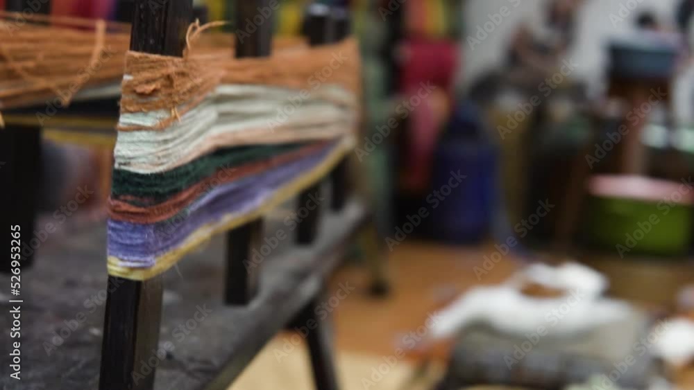 Close up shot of production of fabrics from threads for sewing inside a local production unit. Close up shot of production of fabrics from threads for sewing inside a local production unit.