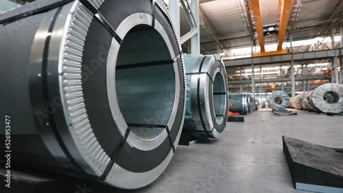 Industrial workshop and warehouse for storage and distribution of products of a metallurgical plant. Coiled steel is stored in rows in a modern warehouse. photo